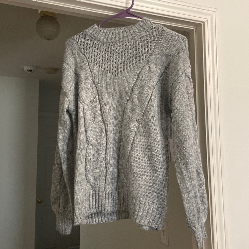 Brand new sweater with tags still on. Never worn. It has sparkle thread.